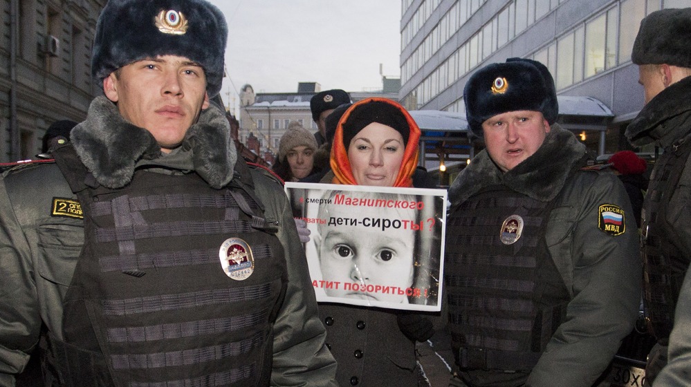 Police officers detain a protester just outside the lower house of Russia's parliament on Wednesday. This week, Russian legislators passed a bill banning Americans from adopting Russian children after the U.S. passed the so-called Magnitsky Act, a law penalizing some Russian officials implicated in the prison death of lawyer Sergei Magnitsky. Police officers detain a protester just outside the lower house of Russia's parliament on Wednesday. This week, Russian legislators passed a bill banning Americans from adopting Russian children after the U.S. passed the so-called Magnitsky Act, a law penalizing some Russian officials implicated in the prison death of lawyer Sergei Magnitsky.