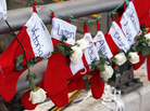 Christmas stockings with the names of shooting victims hang from a railing in the Sandy Hook village of Newtown, Conn. Christmas stockings with the names of shooting victims hang from a railing in the Sandy Hook village of Newtown, Conn.