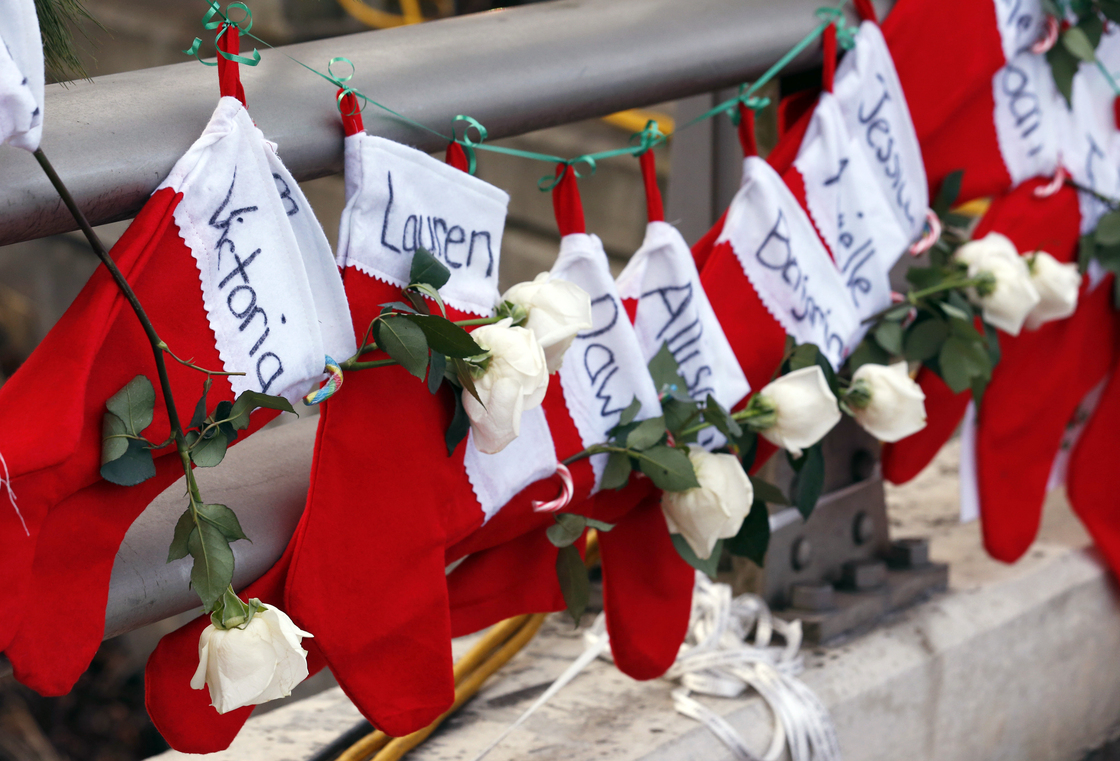 Christmas stockings with the names of shooting victims hang from a railing in the Sandy Hook village of Newtown, Conn.