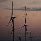 Wind turbines stand alongside an electrical tower at the National Wind Technology Center, run by the U.S. Department of Energy, outside Boulder, Colo.