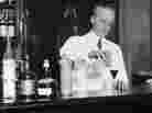 American bartender Harry Craddock mixes a drink at the Savoy Hotel in London in  1926. Craddock is known for helping to popularize the Corpse Reviver, one of the drinks featured in historian Lesley Blume's book about vintage cocktail culture.