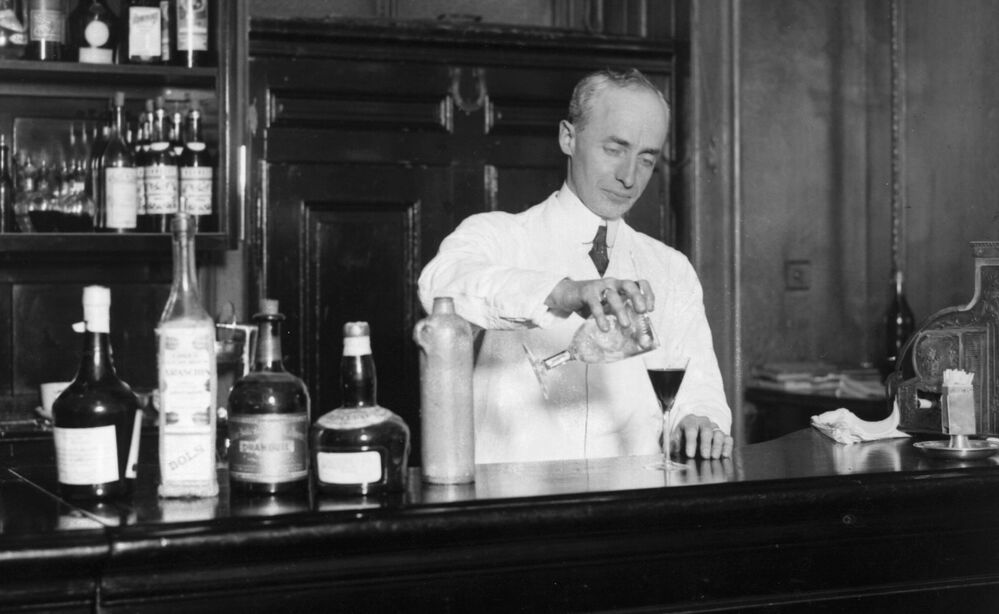American bartender Harry Craddock mixes a drink at the Savoy Hotel in London in 1926. Craddock is known for helping to popularize the Corpse Reviver, one of the drinks featured in historian Lesley Blume's book about vintage cocktail culture.