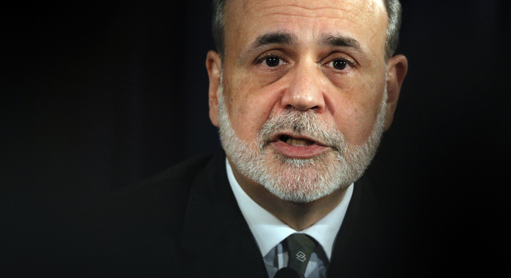 Federal Reserve Chairman Ben Bernanke speaks during a news conference in Washington on Dec. 12. Some economists worry the Fed has set the stage for inflation as well as stock and housing bubbles by keeping interest rates low.