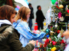 Mourners put decorations on a Christmas tree, part of a memorial in Newtown, Conn. Holiday greetings, toys and cards have flowed into the town, and some residents say the community feels closer-knit since the shooting. Mourners put decorations on a Christmas tree, part of a memorial in Newtown, Conn. Holiday greetings, toys and cards have flowed into the town, and some residents say the community feels closer-knit since the shooting.