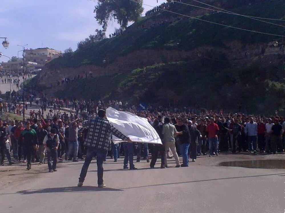 In March 2011, at the beginning of the Syrian uprising, protester Ibrahim Abazid made a massive white flag out of a sugar sack. This picture of him waving the flag in his hometown of Dera'a became a hugely popular image. Now Abazid hopes to serve on a city council in Dera'a.