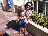 Maya Thompson with Ronan just a few weeks before his death in May 2011. A broviac on his chest administered chemotherapy, platelets and red blood cells when needed. He wanted to play in the hot tub that day, so Maya let him go in up to his midsection to keep the broviac dry.