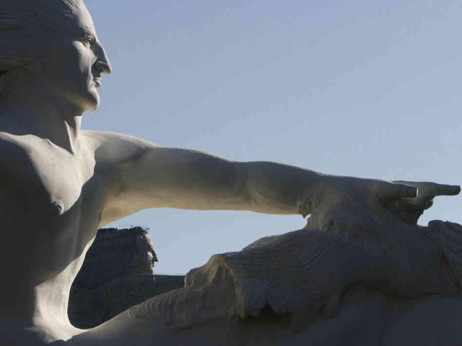 A 1/34th scale model of what the Crazy Horse sculpture will look like, foreground, frames the actual carving in 2006.
