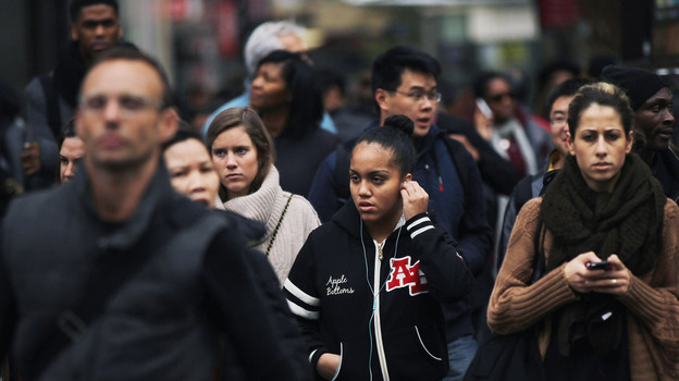 A crowd crosses the street in midtown Manhattan. (Getty Images)