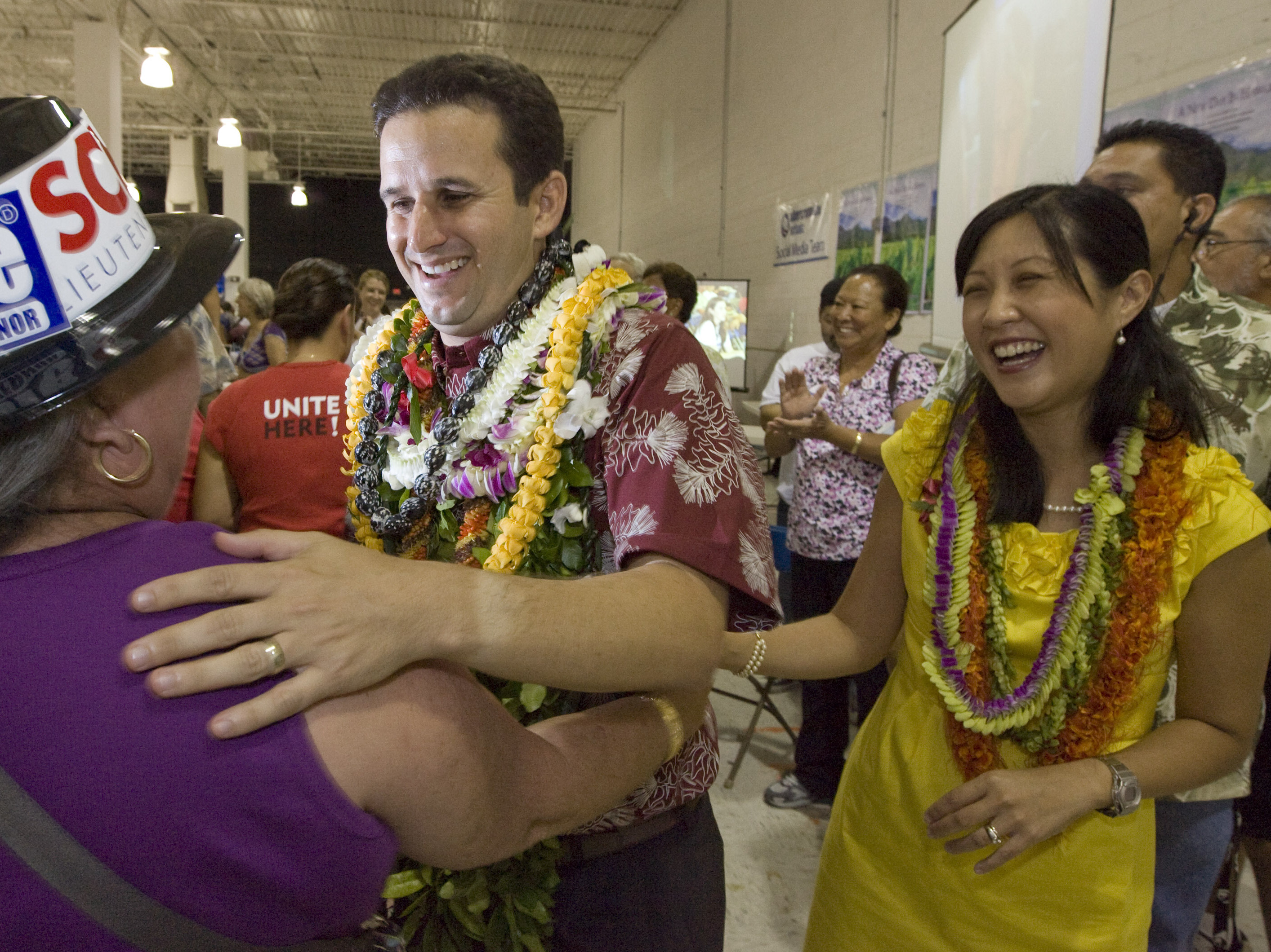 A supporter congratulates Brian Schatz, then newly elected as Hawaii's lieutenant governor, as his wife, Linda, looks on in November 2010. A supporter congratulates Brian Schatz, then newly elected as Hawaii's lieutenant governor, as his wife, Linda, looks on in November 2010.