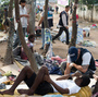 A member of Rio de Janeiro's Social Work Department speaks with crack addicts in  a slum area known as "Crackland," during a police operation in the city in November.
