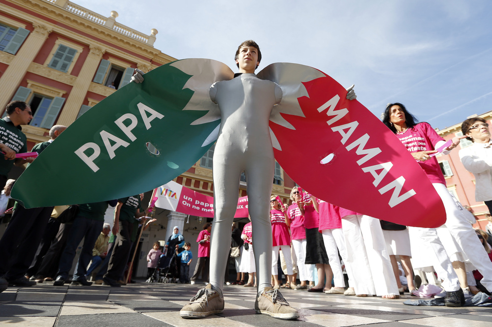 A man wears a costume reading "Dad" and "Mom" during a demonstration against gay marriage and adoption by same-sex couples in Nice, France, in October.