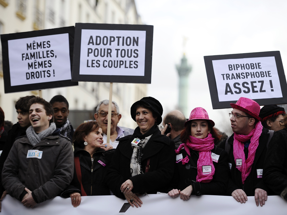 People hold placards reading and support of legalizing marriage and adoption for gay couples, during a demonstration in Paris on Dec. 16.