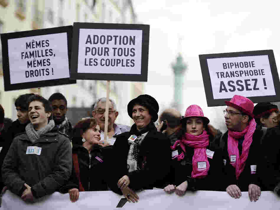 People hold placards reading and support of legalizing marriage and adoption for gay couples, during a demonstration in Paris on Dec. 16.