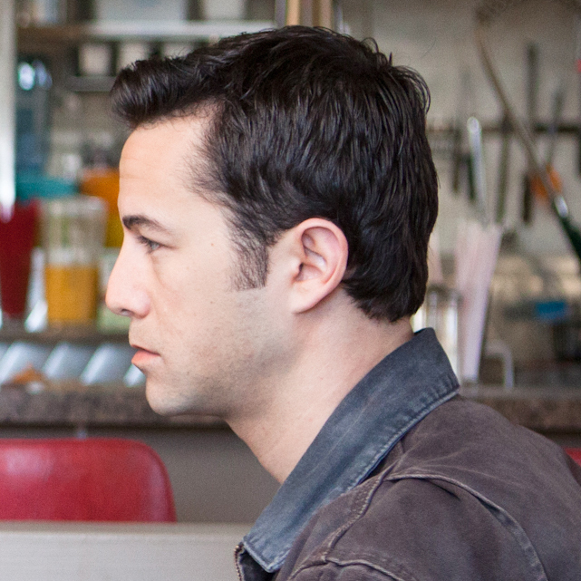 Young Joe (Joseph Gordon-Levitt) and Old Joe, the same man at two different moments of his life, stare each other down.