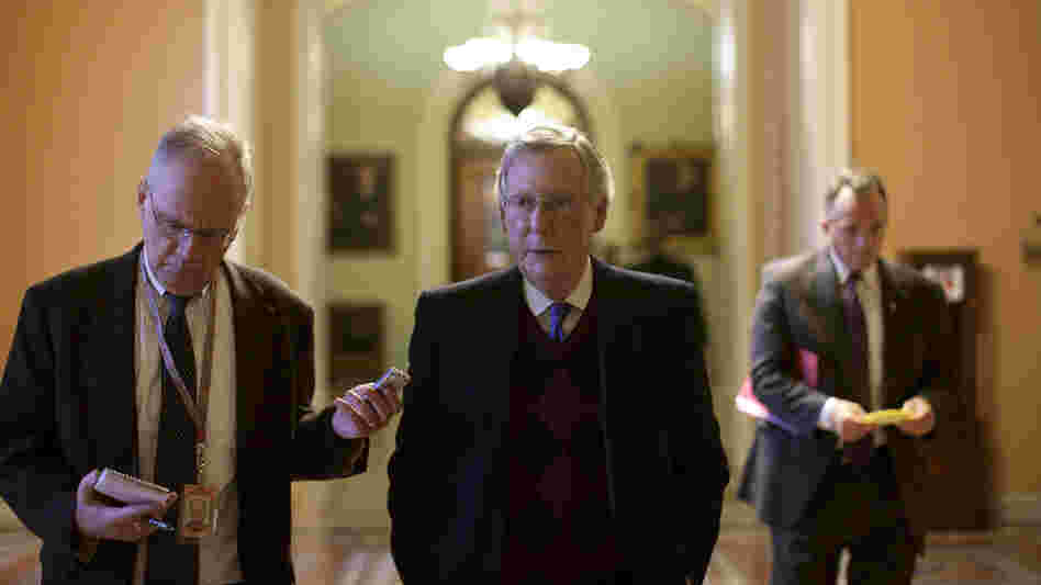 Senate Minority Leader Mitch McConnell walks toward his office after speaking on the Senate floor on Capitol Hill. McConnell and other congressional leaders will meet with President Obama Friday.