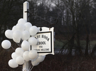 After the attack: Balloons hung from the Sandy Hook Elementary School sign on Dec. 15. On Dec. 14, six adults and 20 children were killed there before the gunman took his own life. After the attack: Balloons hung from the Sandy Hook Elementary School sign on Dec. 15. On Dec. 14, six adults and 20 children were killed there before the gunman took his own life.