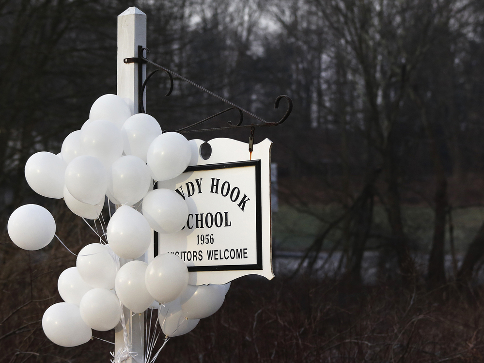After the attack: Balloons hung from the Sandy Hook Elementary School sign on Dec. 15. On Dec. 14, six adults and 20 children were killed there before the gunman took his own life.