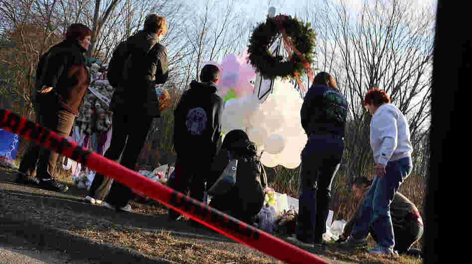 People visit a memorial outside the Sandy Hook School on Dec. 15 in Newtown, Conn.