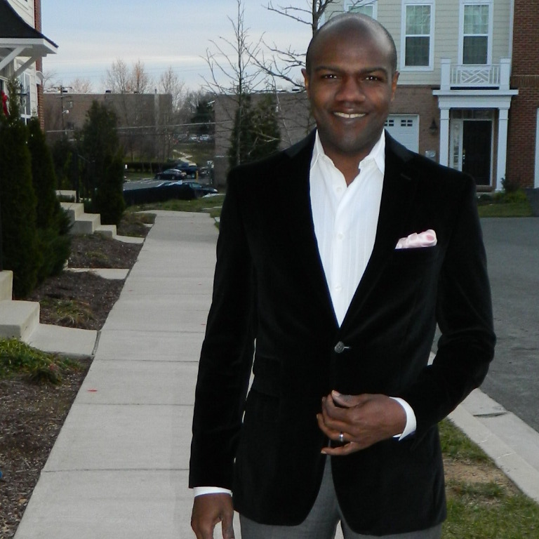Tell Me More's Barbershop and political chat contributor Corey Ealons is outfitted in a Joseph Abboud black velvet jacket with a ticket pocket and pink silk handkerchief. Ealons says real men can wear pink with confidence, and that his style is classic and clean with a little edge.