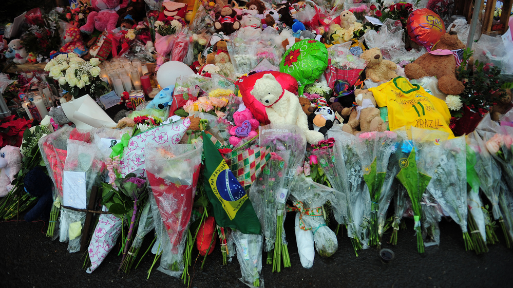 A makeshift shrine to the victims of the school shooting in Newtown, Conn. Slate and a citizen journalist are trying to track gun deaths across the nation since that Dec. 14 mass shooting.