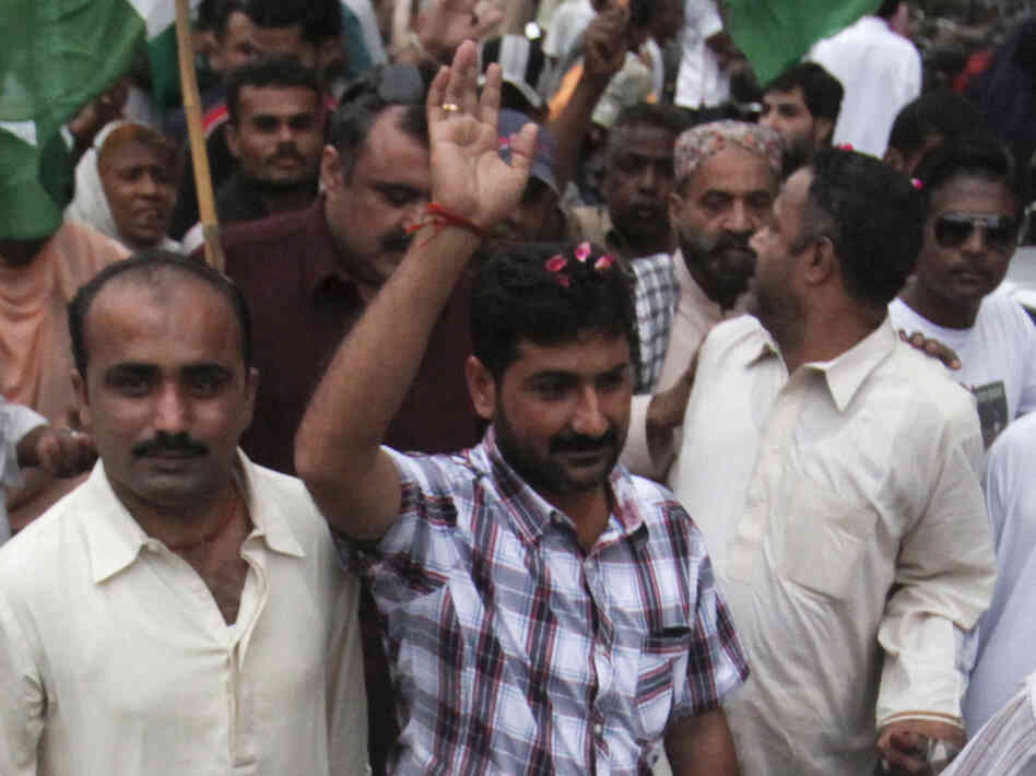 Uzair Baloch (center), 32, controls an impoverished section of Karachi and commands a large armed force. He is routinely described as a gangster, though he calls himself a politician and a social worker. He's shown here at a rally in Karachi in November 2011.