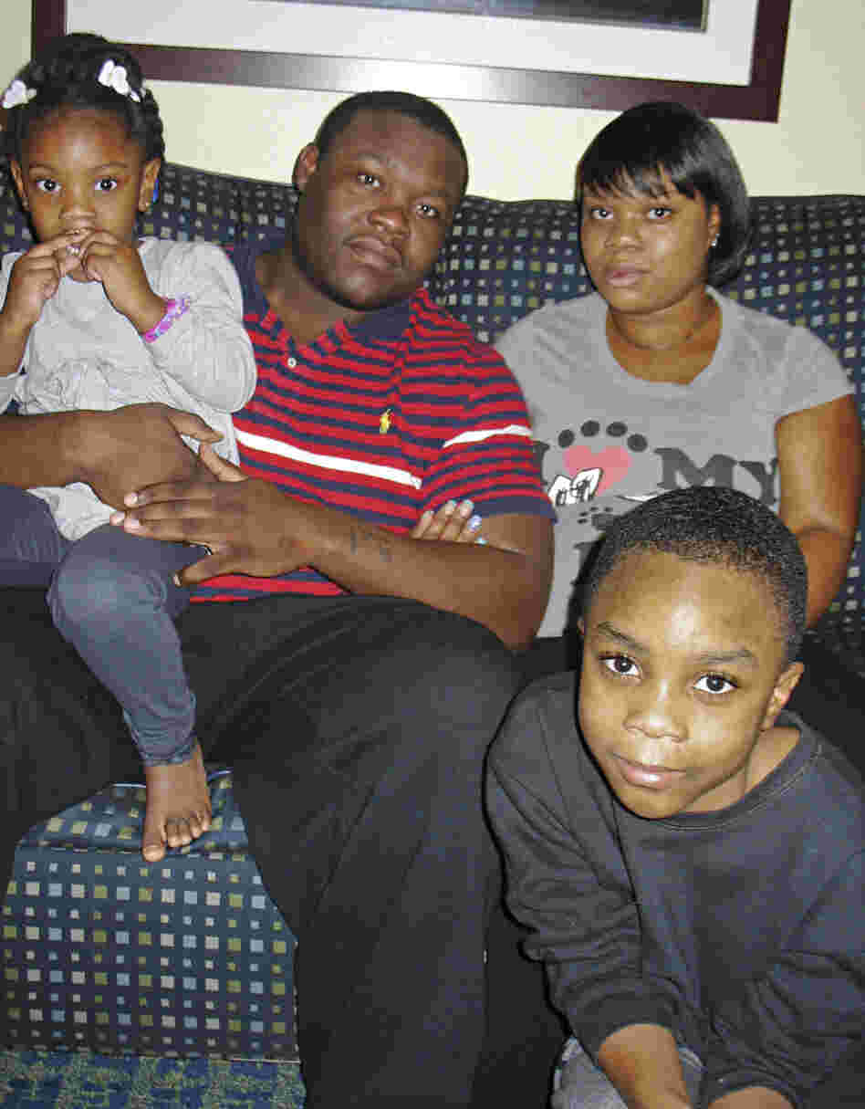 Natisha Laws and her partner, Mark Douglas, inside the Times Square hotel room where they've been staying since mid-November. The tourist hot spot is exciting for 3-year-old Tru and 9-year-old Isaiah, but their parents say they are stressed out and worry the family will end up homeless.