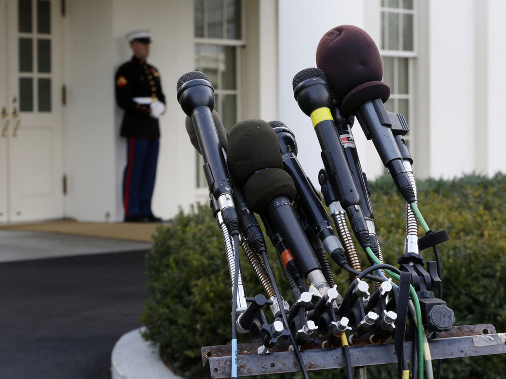Microphones stand outside the White House on Friday, ready should word of a fiscal cliff deal strike.