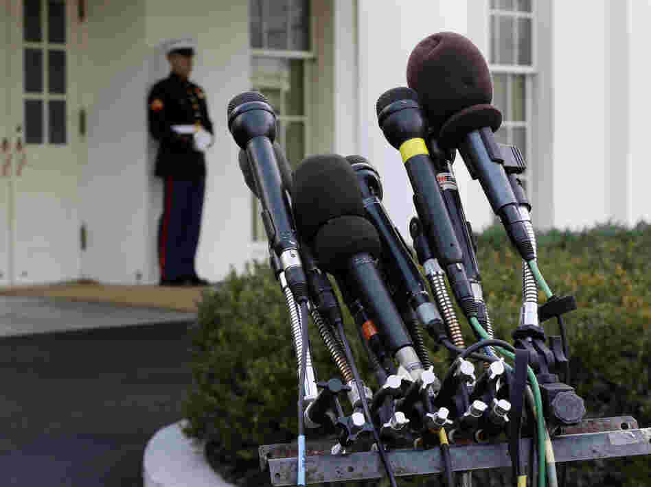 Microphones stand outside the White House on Friday, ready should word of a fiscal cliff deal strike.