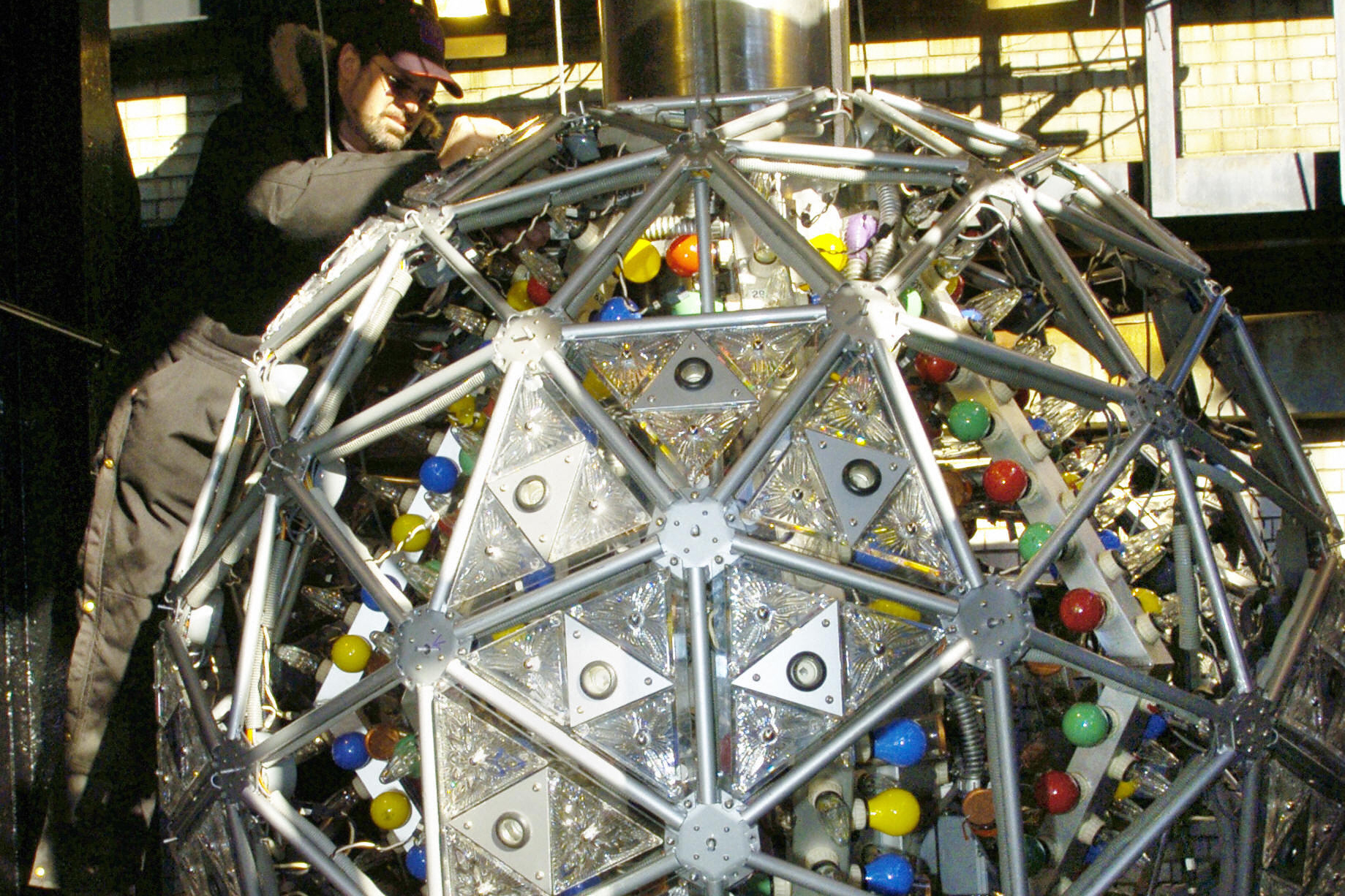 A technician installs one of 72 new Waterford Crystal triangles, featuring the 