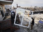 Contractors Benny Corrazo, left, and Michael Bonade install a new set of sliding glass doors in a home that survived Superstorm Sandy in the Breezy Point section of New York on Dec. 20, 2012. Some economists say that reconstruction efforts may stimulate the economy. Contractors Benny Corrazo, left, and Michael Bonade install a new set of sliding glass doors in a home that survived Superstorm Sandy in the Breezy Point section of New York on Dec. 20, 2012. Some economists say that reconstruction efforts may stimulate the economy.