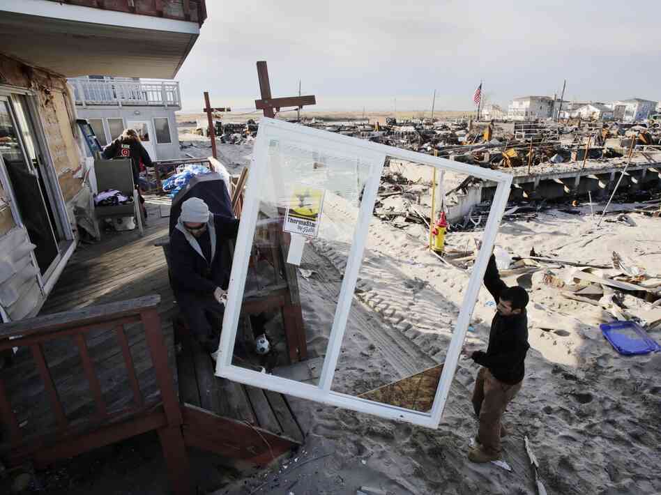 Contractors Benny Corrazo, left, and Michael Bonade install a new set of sliding glass doors in a home that survived Superstorm Sandy in the Breezy Point section of New York on Dec. 20, 2012. Some economists say that reconstruction efforts may stimulate the economy. Contractors Benny Corrazo, left, and Michael Bonade install a new set of sliding glass doors in a home that survived Superstorm Sandy in the Breezy Point section of New York on Dec. 20, 2012. Some economists say that reconstruction efforts may stimulate the economy.