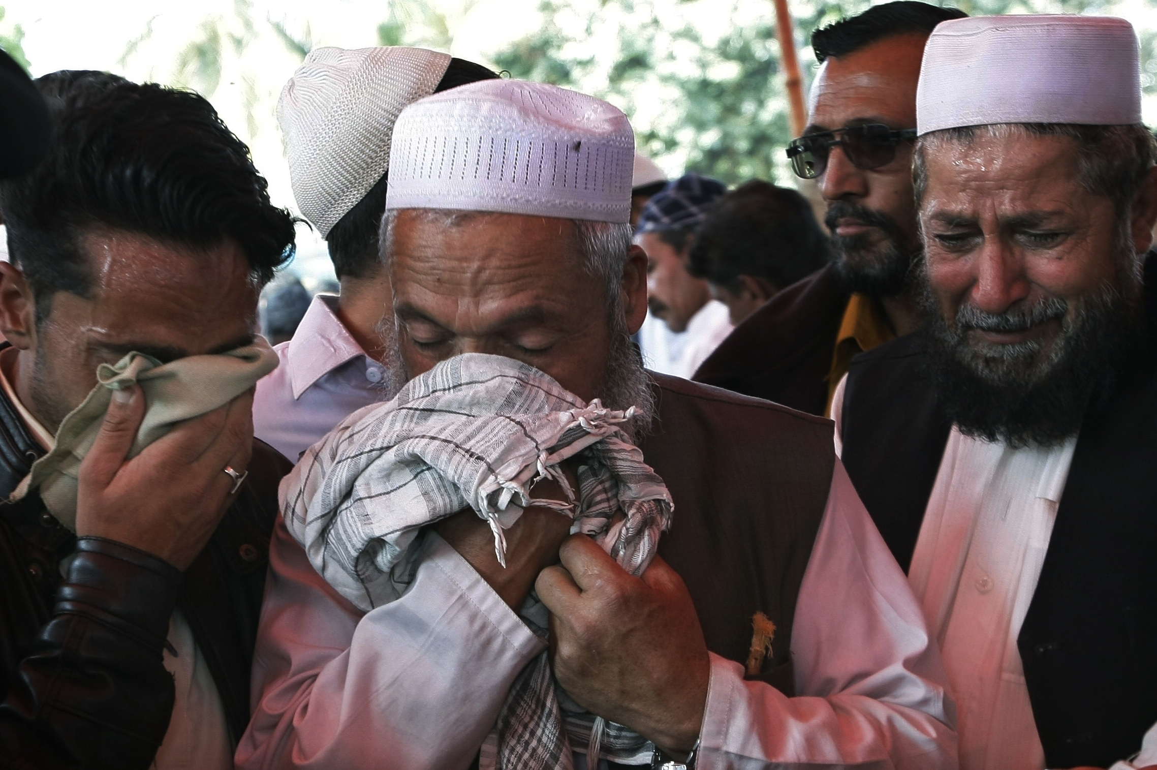 Men mourn over the deaths of their family members during their funeral procession in Karachi, Pakistan last week. Police said gunmen have wounded a prominent Sunni cleric and killed his guards and his driver in an apparently sectarian attack in southern Pakistan.