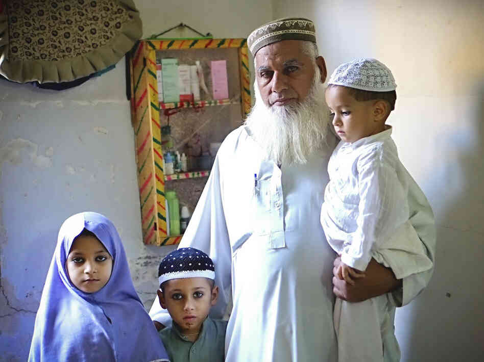 Gul Mohammed Khan has lost three sons in sectarian violence during the last two years, in Karachi, Pakistan. He stands here with some of his grandchildren who have lost their fathers. When he looks at his grandchildren, he says, he sees his sons.