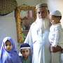 Gul Mohammed Khan has lost three sons in sectarian violence during the last two years, in Karachi, Pakistan. He stands here with some of his grandchildren who have lost their fathers. When he looks at his grandchildren, he says, he sees his sons.