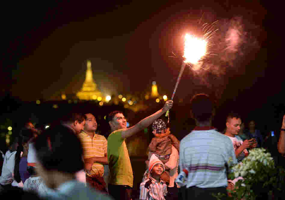 People wait before the countdown to the New Year near the Shwedagon Pagoda in Yangon, Myanmar. Some 50,000 people were expected to gather for the city's first ever public countdown to the New Year and fireworks.