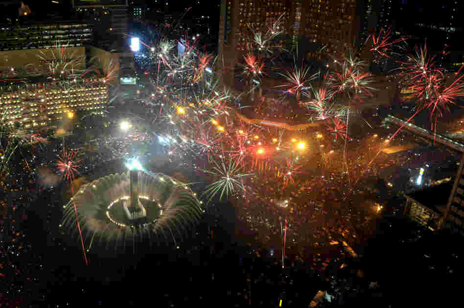 Fireworks are launched over Jakarta's main business road to mark the new year.