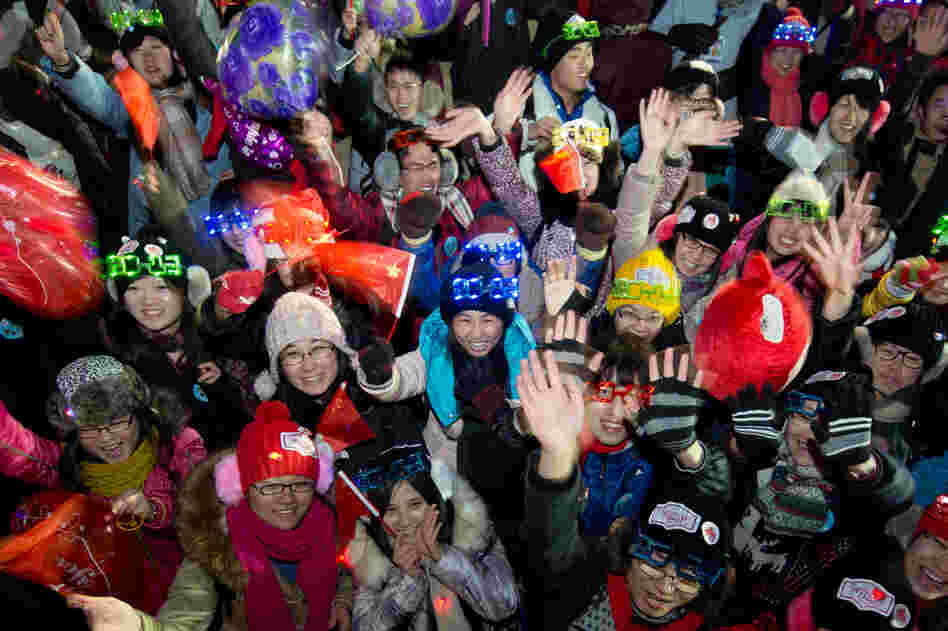 People cheer following a count-down event at the Summer Palace in Beijing.