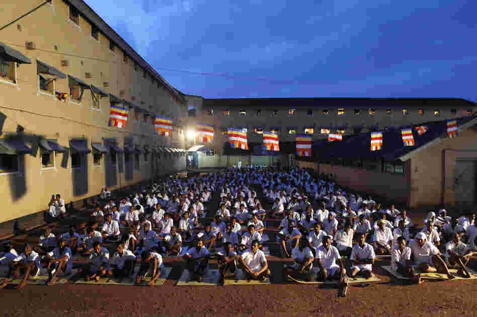 Sri Lankan inmates at the Welikada prison pray during a religious ceremony. Over four thousand prisoners at one of the country's largest prisons invoked blessings and ushered in the new year by engaging in Buddhist rituals.