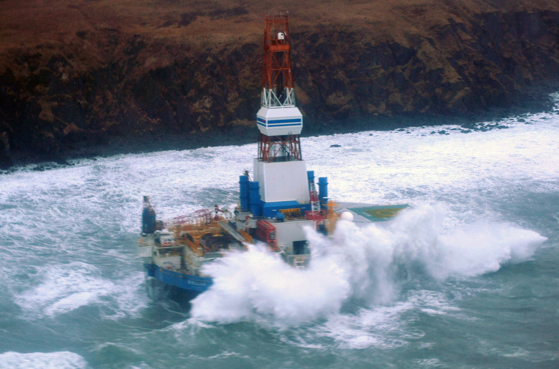 Waves crash over the Kulluk oil rig, which washed aground on Sitkalidak Island, Alaska. Officials say aircraft have not spotted any signs of a fuel leak from the rig, which reportedly does not contain crude oil.