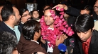 Pakistanis welcome Muhammad Shahid Nazir, center, the singer of "One Pound Fish," at Lahore's airport Thursday. Pakistanis welcome Muhammad Shahid Nazir, center, the singer of "One Pound Fish," at Lahore's airport Thursday.