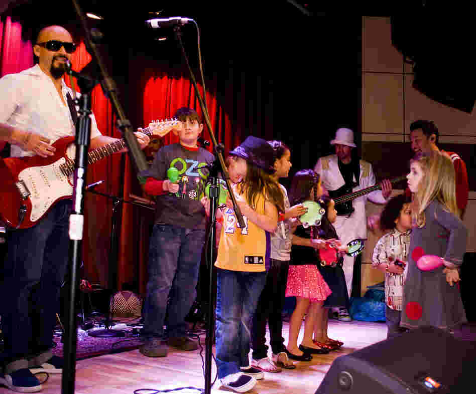 Ozomatli invites kids onstage for a performance. Ozomatli invites kids onstage for a performance.