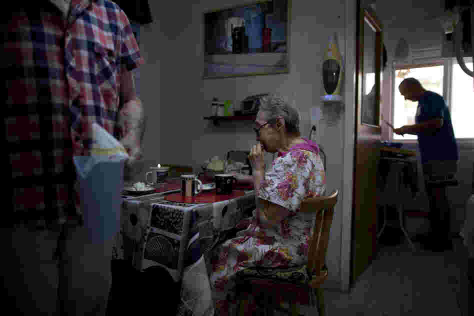 Bella Perlin (center) and Avraham Shapiro (left), Belarusian immigrants, eat breakfast at their home in Hadera, northern Israel. They moved to Israel in 1991 at the height of the wave of immigration from the former Soviet Union.