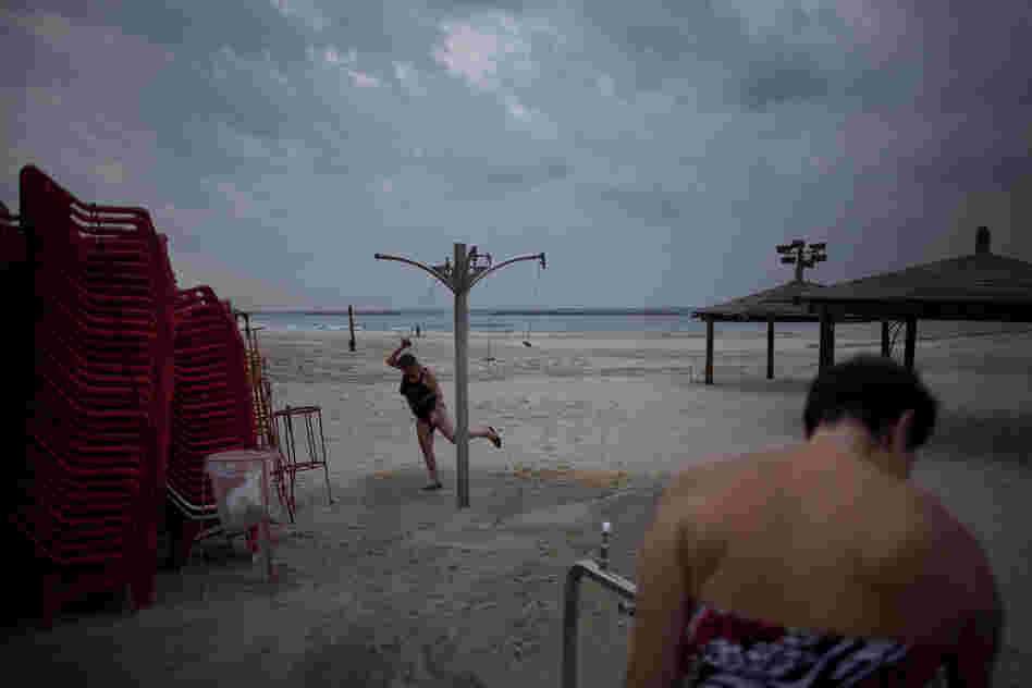 Two immigrants from the Ural region of the former Soviet Union rinse off after bathing in the Mediterranean Sea on an early December morning in Tel Aviv. Many Soviet immigrants gather at the beach for a traditional winter dip, the closest substitute to the freezing waters of the former Soviet Union.