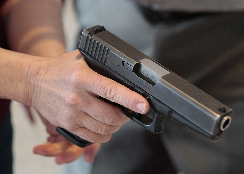 WEST VALLEY CITY, UT - DECEMBER 27: A Utah teacher is shown how to handle a handgun by instructor Clint Simon at a concealed-weapons training class to 200 Utah teachers on December 27, 2012 in West Valley City, Utah. The Utah Shooting Sports Council said it would waive its $50 fee for concealed-weapons training for Utah teachers. (Photo by George Frey/Getty Images)