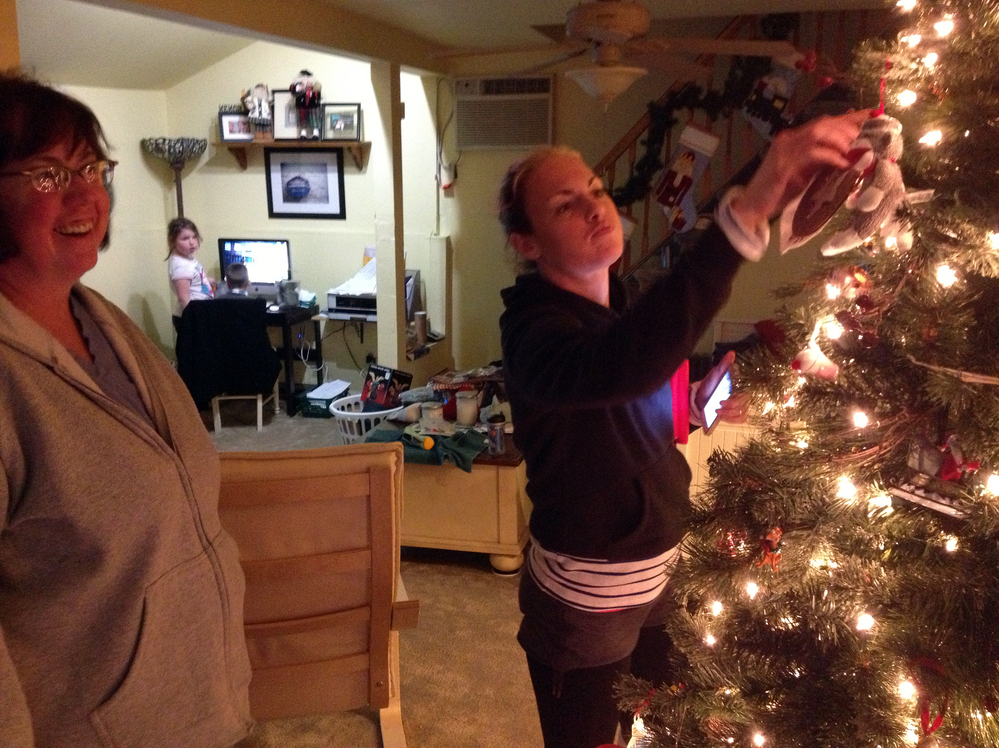 After Sandy, the Hardys' goal was to get their house together enough to have a normal Christmas. The ornaments survived the storm. Shown here, from left, are Linda Hardy, her granddaughter Annie and her daughter Heather.
