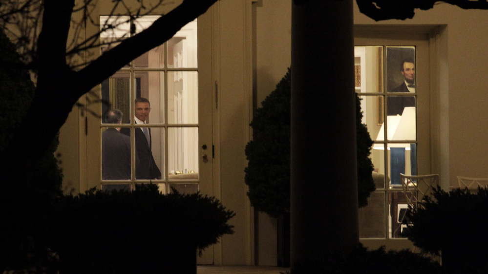 President Obama was in the Oval Office late Tuesday night as the House finished voting on the "fiscal cliff" deal. After praising the passage, he left for Hawaii to resume a vacation with his family.