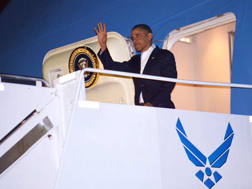 President Barack Obama steps off Air Force One at Hickam Air Force Base near Honolulu, Hawaii, Wednesday. Obama returned to Hawaii to continue his vacation — prompting questions about how he will sign the fiscal cliff bill.