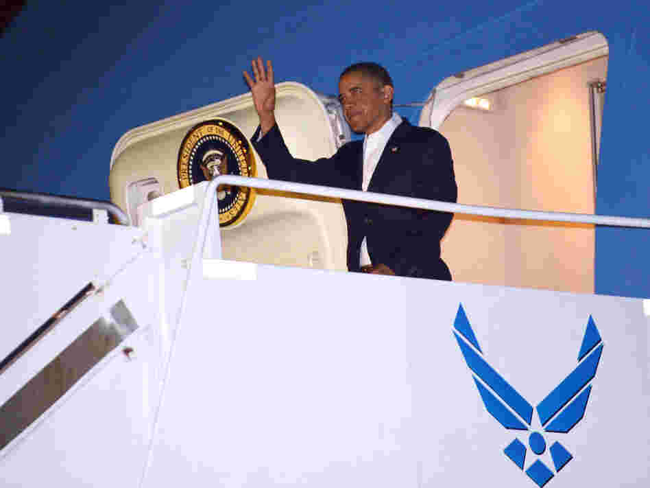 President Barack Obama steps off Air Force One at Hickam Air Force Base near Honolulu, Hawaii, Wednesday. Obama returned to Hawaii to continue his vacation — prompting questions about how he will sign the fiscal cliff bill.