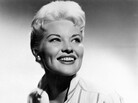 Patti Page — known for such songs as "Tennessee Waltz" and "How Much Is That Doggie in the Window?" — is seen here in 1958. Page died Tuesday at age 85. Patti Page — known for such songs as "Tennessee Waltz" and "How Much Is That Doggie in the Window?" — is seen here in 1958. Page died Tuesday at age 85.