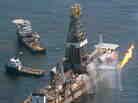 The Transocean Discoverer Enterprise drill ship collects oil from the site of the Deepwater Horizon oil well as workers try to stem the flow of the spill in the Gulf of Mexico, June 12, 2010.